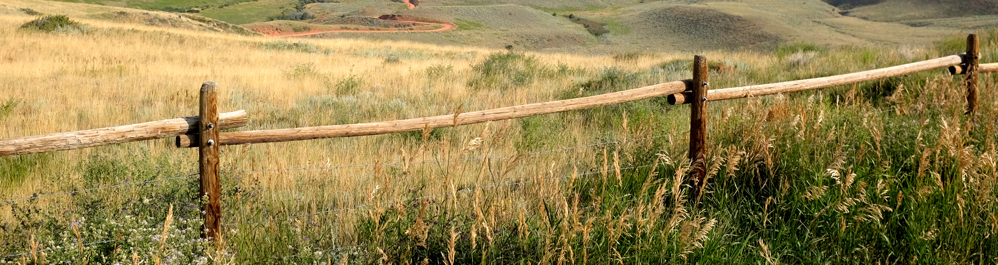 View of Red Canyon off of WY Highway 28 in Wyoming with fence in foreground.